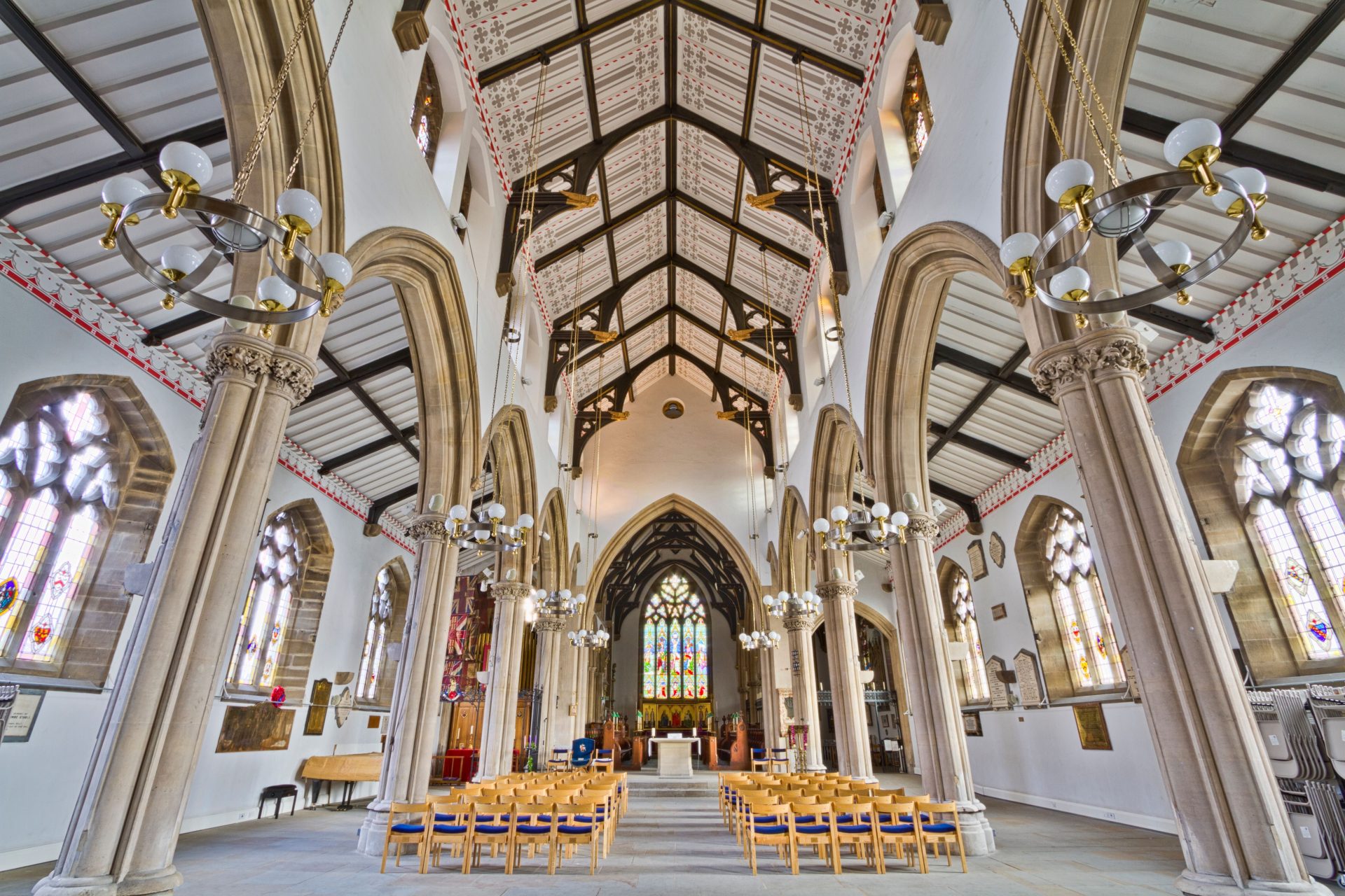 Stunning Gothic interior of St John's Minster in England showcasing arches, stained glass, and architectural beauty.